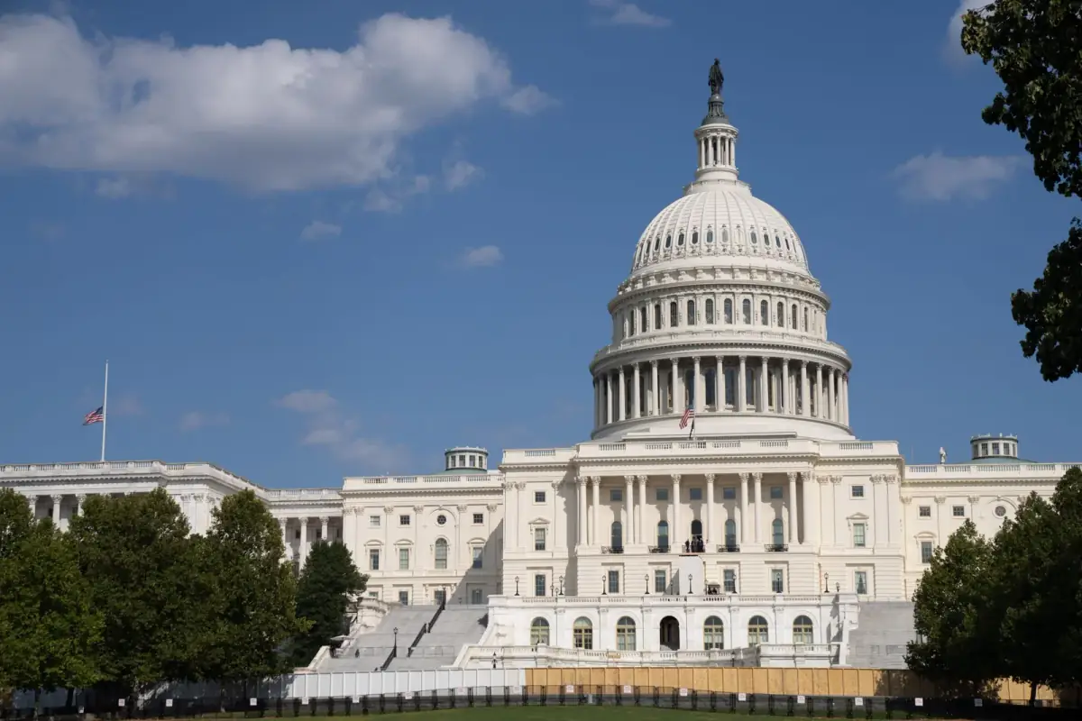 Historic United States Capitol building and dome in Washington DC beneath blue skies on a sunny day